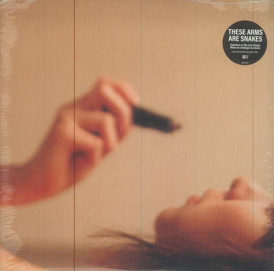 the album cover for These Arms Are Snakes - Oxeneers Or The Lion Sleeps When Its Antelope Go Home [Indie Exclusive Limited Edition Orange LP]